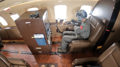 Air Crewman Officer monitors dropsonde data during the mission 